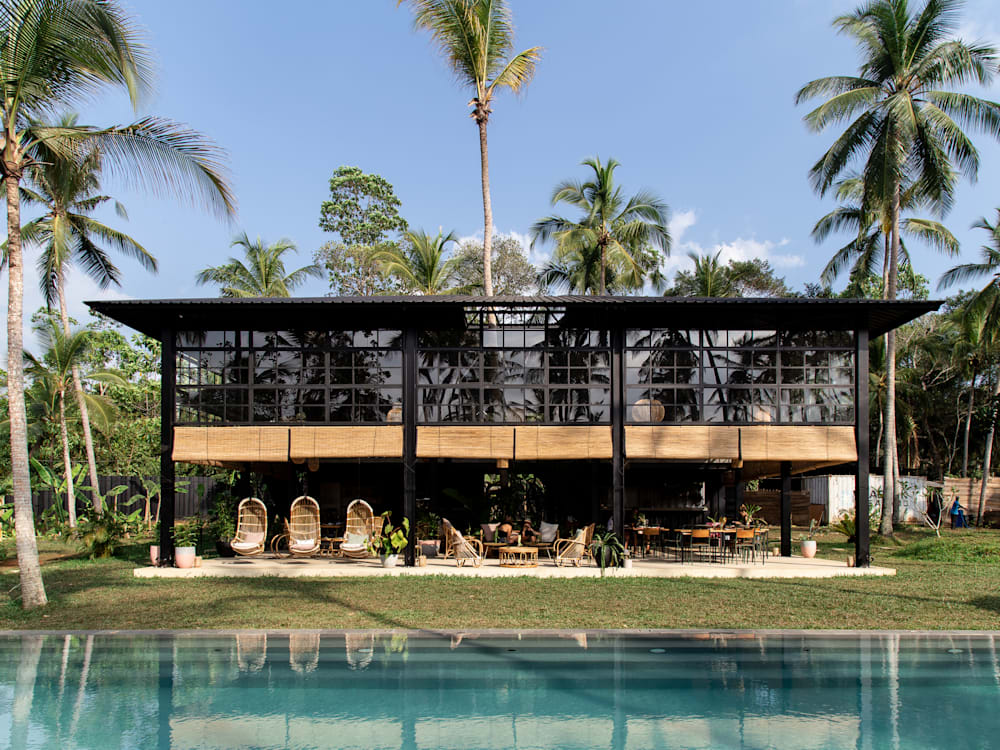 Hotel exterior and swimming pool under bright blue sunny skies