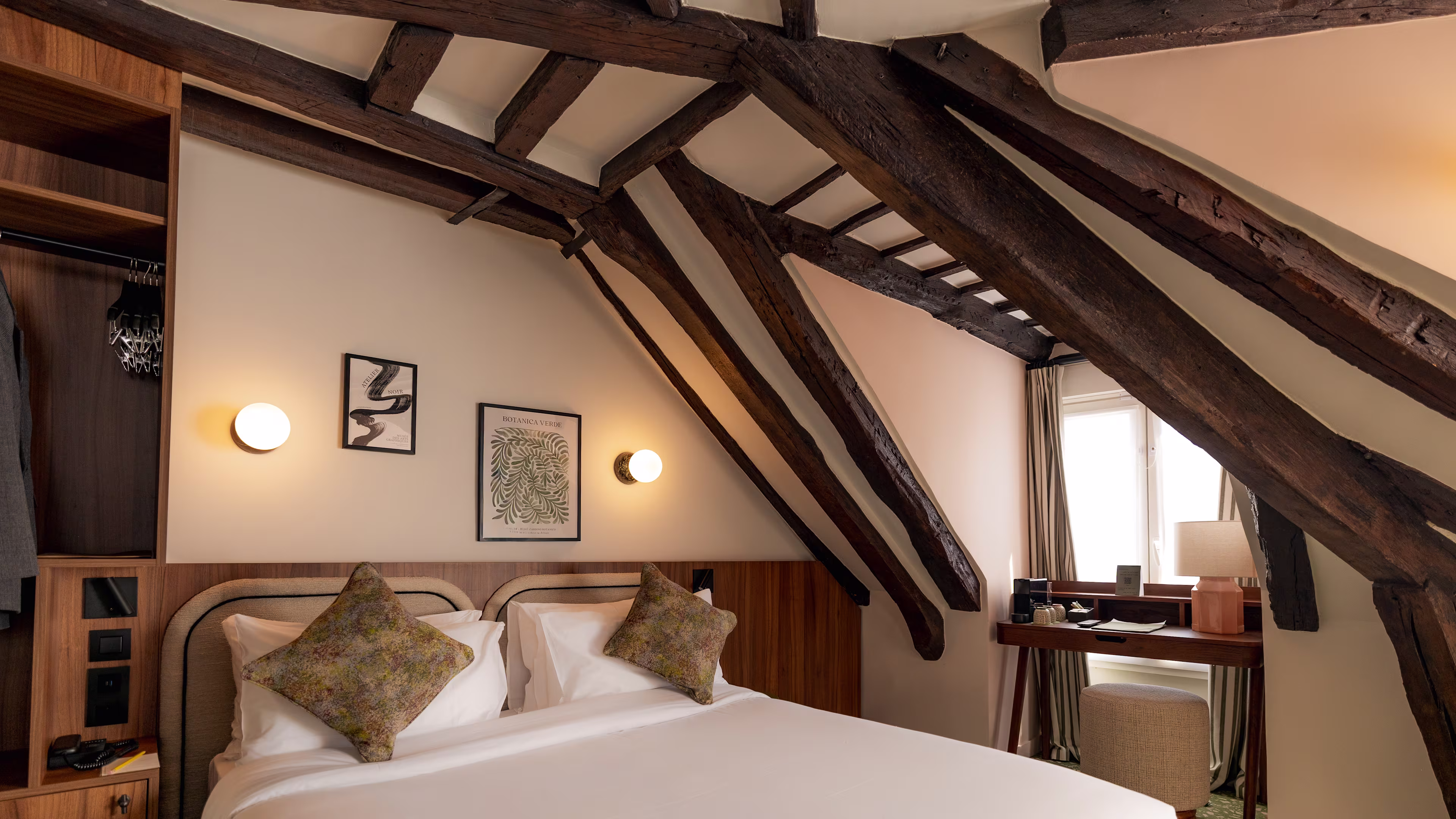 Elegant empty Paris hotel room with wooden beams and comfortable bed