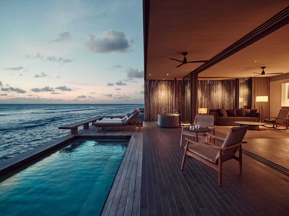 Side view of room and swimming pool looking out onto the ocean