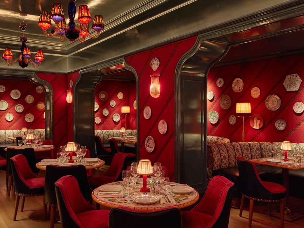 Red restaurant with painted plates hanging on the walls.