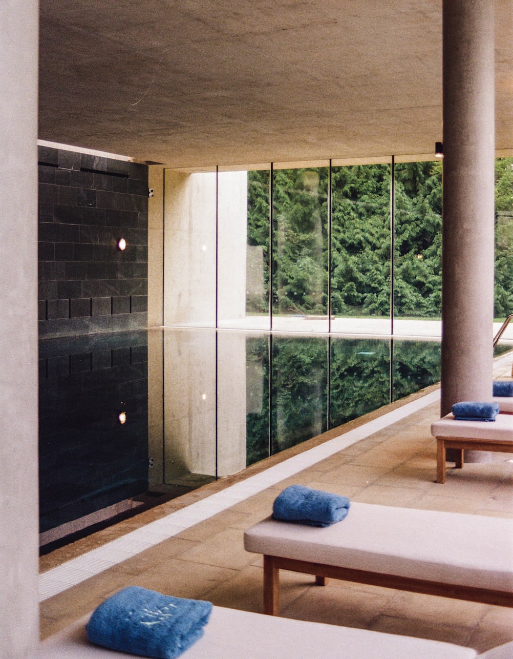 Image of an indoor pool and loungers at Cowley Manor.